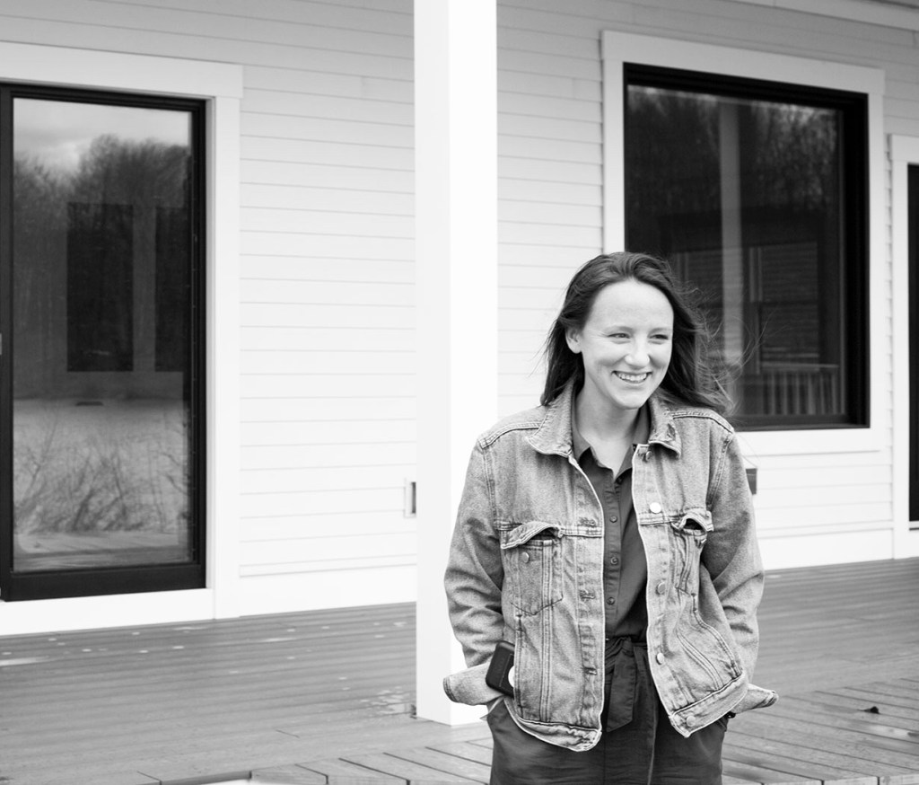 Black and white image of woman smiling, looking to the right